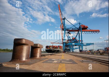 Hamburg, Germany. 16th July, 2020. A ship is loaded and unloaded at Container Terminal Altenwerder in the Port of Hamburg by container gantry cranes. Credit: Daniel Reinhardt/dpa/Alamy Live News Stock Photo