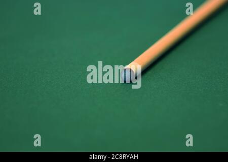 Pool cue on a green felt pool table Stock Photo