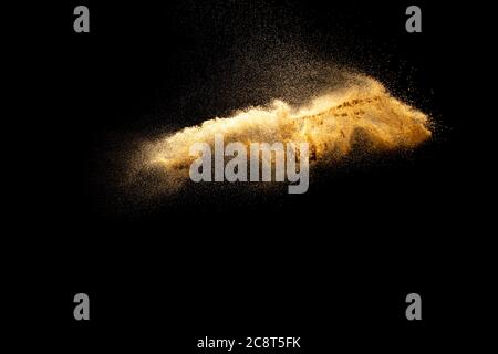 Abstract motion blurred brown sand background.Sandy explosion isolated on over dark background. Stock Photo