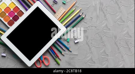 School supplies center composition on grey .concrete background Stock Photo