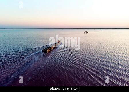 train travels from water. Mined salt in Lake Burlin. Altai. Russia. Bursolith. Old train rides on the railway laid in the water through the salt lake Stock Photo