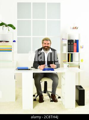 Man sit office. Business director. Bearded hipster creative director. Advocacy and jurisprudence. Legal services director. Case manager track paperwork and other important information about case. Stock Photo