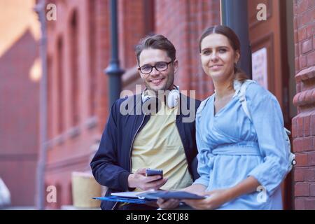 Couple of students in the campus studying outdoors Stock Photo