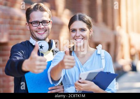 Couple of students in the campus studying outdoors Stock Photo