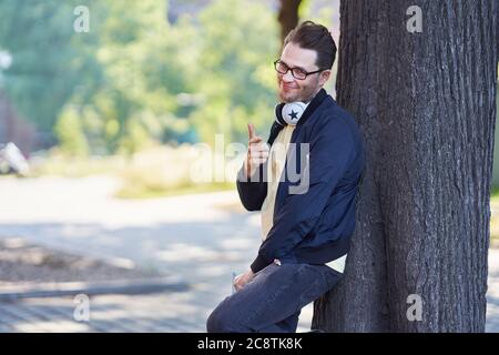 Male student in the campus studying outdoors Stock Photo