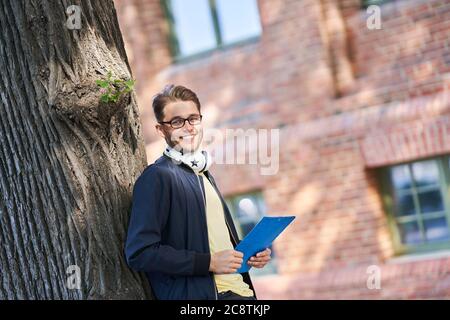 Male student in the campus studying outdoors Stock Photo