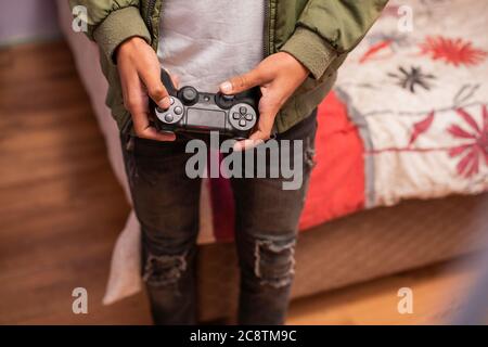 Cropped shot of teenager using remote control Stock Photo