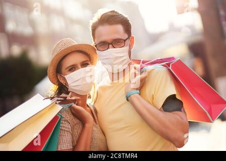 A picture of couple with shopping bags and protective masks Stock Photo