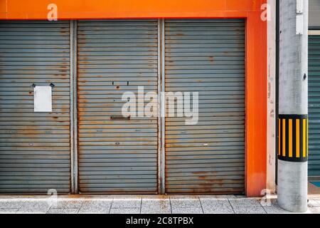 Closed metal shutter door of building. Japanese street view Stock Photo
