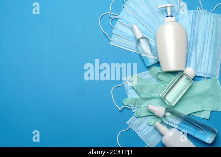 coronavirus COVID-19 pandemic concept - background made of antiviral surgical protective medical masks, rubber latrex gloves and alcohol hand Stock Photo