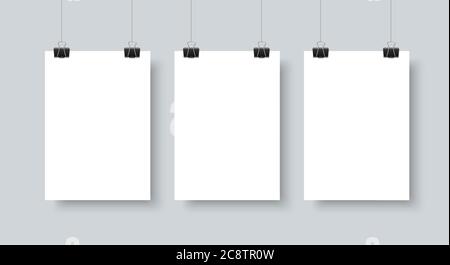 Posters hanging with paper clip realistic vector mock up for gallery. White paper sheets on gray wall background Stock Vector