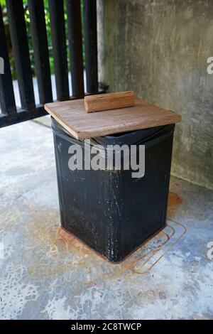 Close up black tin trash bin with wooden lids Stock Photo