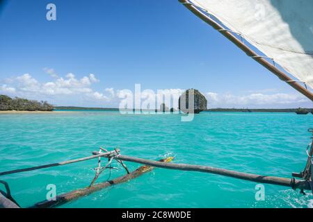 Boat trip on a traditional caledonian sailing boat in Upi bay, Isle of pines, New Caledonia. typical rocks in turquoise sea Stock Photo