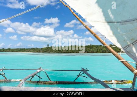 Boat trip on a traditional caledonian sailing boat in Upi bay, Isle of pines, New Caledonia. typical rocks in turquoise sea Stock Photo