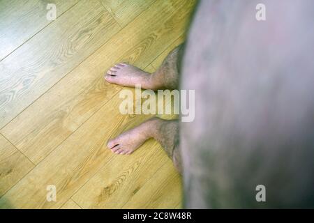 Obese mans point of view looking at his feet Stock Photo