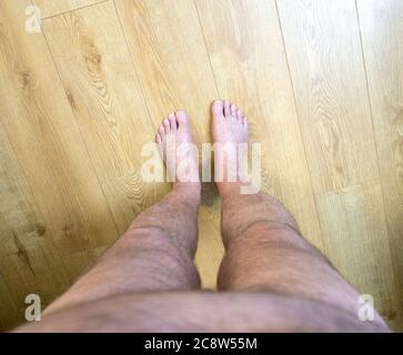 Obese mans point of view looking at his feet Stock Photo