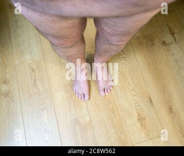 Obese mans point of view looking at his feet Stock Photo