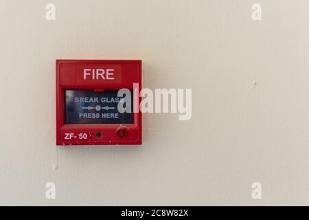 Industrial Fire Emergency Warning System on wall, break glass for urgent emergency. Copy Space Stock Photo