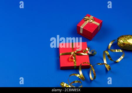 two red gift boxes on blue background. Stock Photo