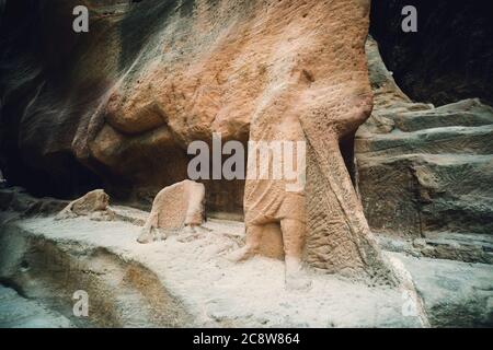 Remains of ancient statues in the Siq in Petra, Jordan Stock Photo