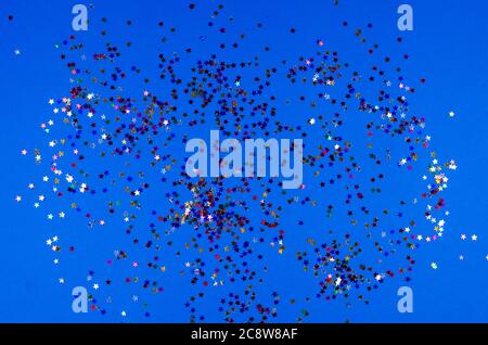 Shining little colorful stars on blue background. Stock Photo