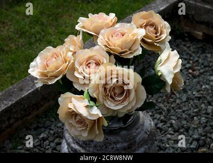 Artificial flowers on a grave, UK Stock Photo