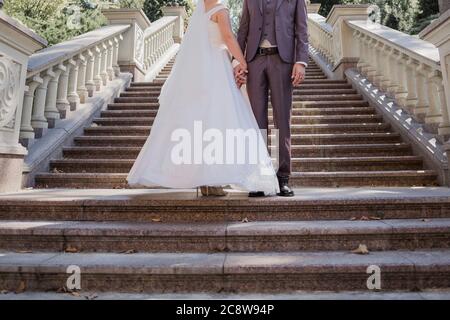 groom with bride on the stairs near the building Stock Photo