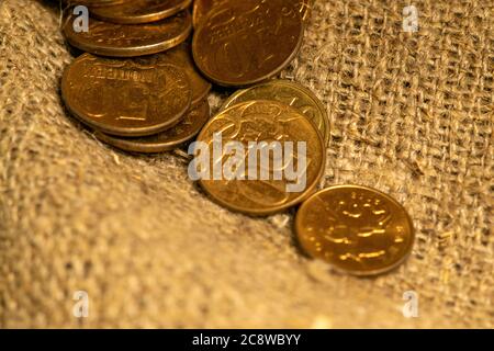 A few old coins on a background of rough-textured fabric. Close up Stock Photo