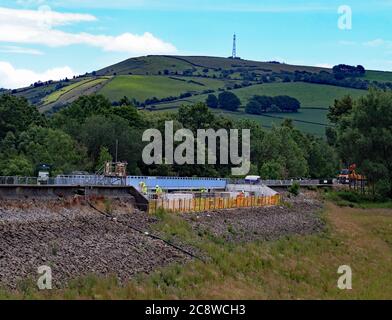 Remedial work at Toddbrook Reservoir 23.6.20. Workers from Kier are in the process of constructing a new concrete wall on the top of the spillway Stock Photo