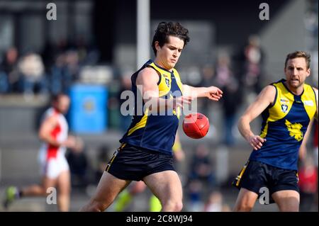 A Mansfield Eagles player prepares for the drop kick during a football match in North East Victoria, Australia Stock Photo