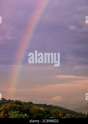 A beautiful rainbow on the cloudy sky Stock Photo