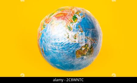 The planet earth is wrapped in plastic. Ecological disaster concept Stock Photo