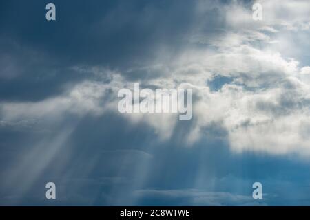 Sun rays break through the stormy clouds. Stock Photo