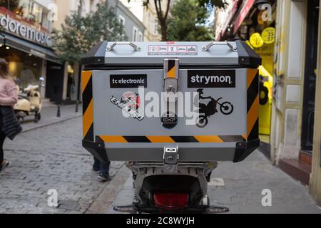An adventure motorcycle cargo case and helmet beside white crossover ...