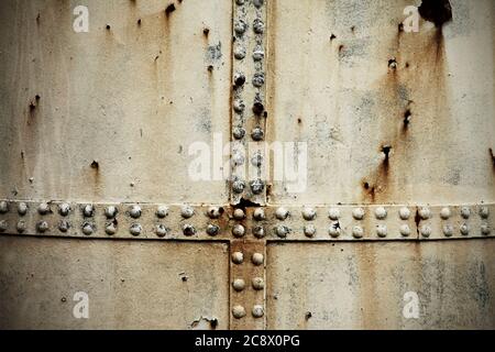 Rusty riveted steel plates. Stock Photo