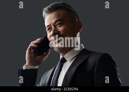 Holding a cell phone business men Stock Photo