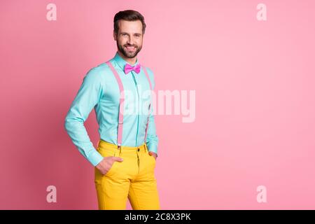 Portrait of his he nice attractive glad content cheerful cheery bearded guy artist mc posing holding hands in pockets isolated over pink pastel color Stock Photo