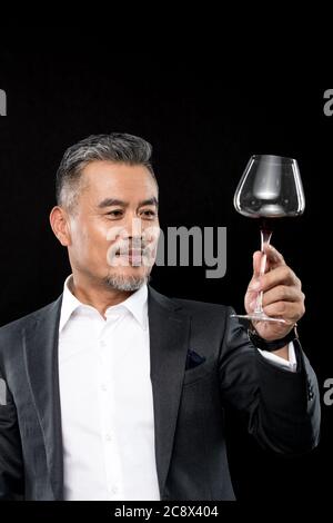 Holding a red wine business in middle-aged men Stock Photo