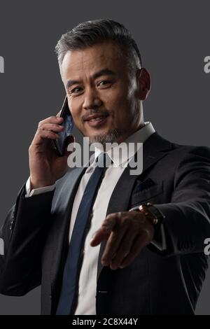 Holding a cell phone business men Stock Photo