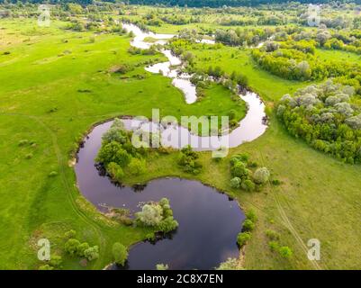 aerial drone landscape of river in green field, top view of beautiful nature texture from drone Stock Photo