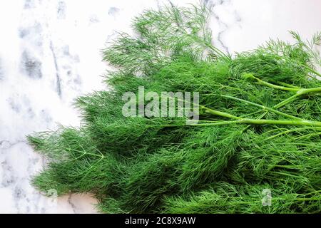 Close up of fresh dills on a marble table, shot from above Stock Photo