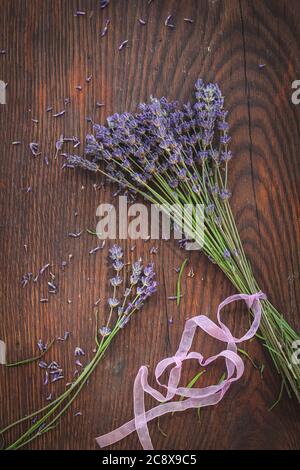 Dried lavender on a dark wooden table, shot from above Stock Photo