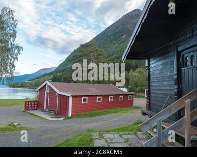 View of Classical Norwegian Camping site Bravoll with traditional wooden cottages cabins at Kinsarvik by the Sorfjorden branch of Hardanger Fjord in Stock Photo