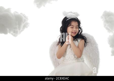 Happy little angel praying Stock Photo