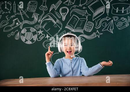 Sitting in front of the blackboard primary school girls in the class Stock Photo