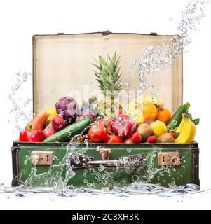 fresh fruit in suitcase falling in water Stock Photo