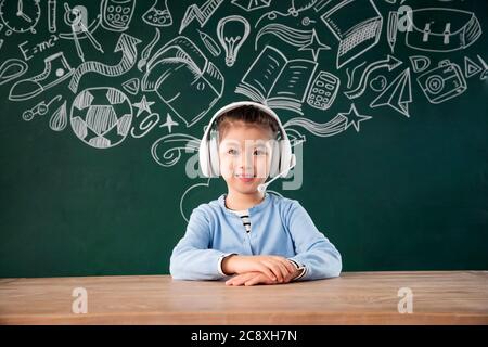 Sitting in front of the blackboard primary school girls in the class Stock Photo