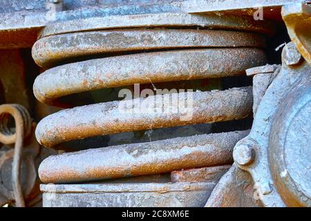 Old heavy rusted dirty iron spring under a railway wagon Stock Photo