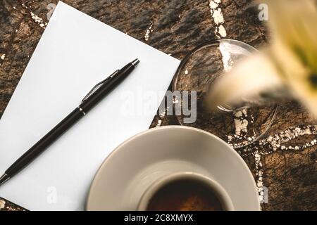 Hot coffee with blank paper note on wood background Stock Photo