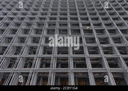 Steel mesh panels used in construction reinforcement. Abstract industrial background. Stock Photo